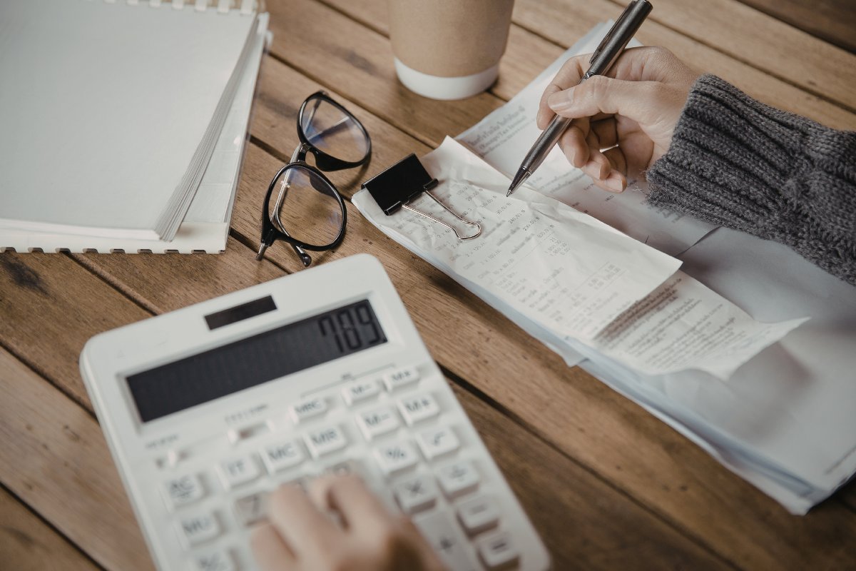 Person calculating finances at desk.